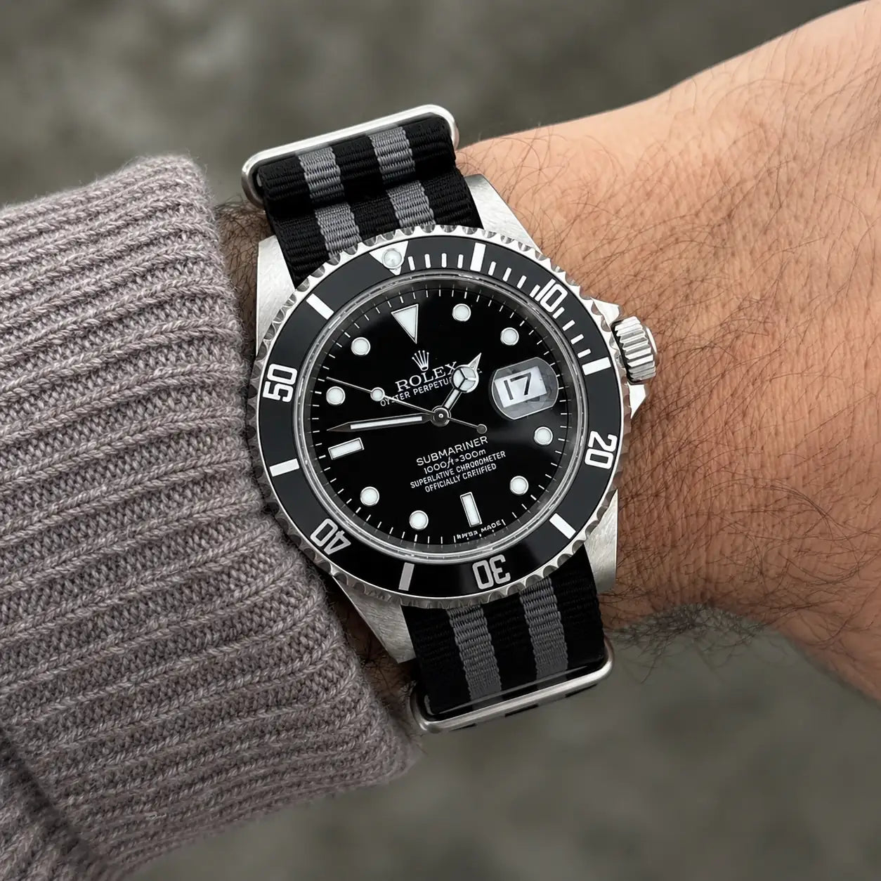 Black and grey nylon NATO strap for Rolex Submariner worn on the wrist - Maison Brassel